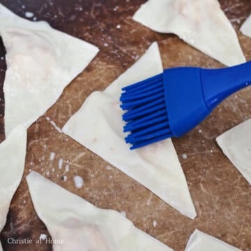 Pre-heat the oven to 375 degrees F. Place the wontons on a large baking sheet lined with parchment paper. Lightly brush milk over the top of the wontons with a silicone brush. Then lightly spray wontons with vegetable oil or any neutral oil.