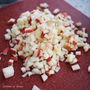 Slice unpeeled apples into thin matchsticks and then finely dice them.