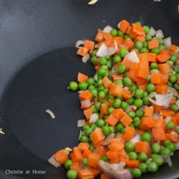 Garlic, shallots, peas, and carrots sautéed together.