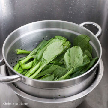 Yu choy washed in cold water to remove dirt between the leaves.