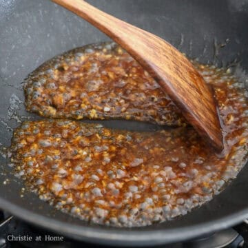 Garlic sauce simmering until glossy and slightly thickened.