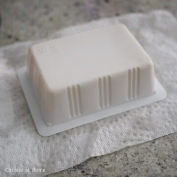 Silken tofu draining upside down on a clean paper towel.