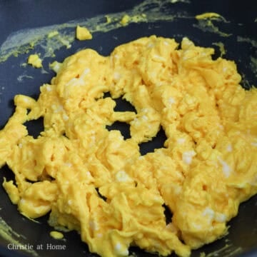 Soft scrambled eggs cooked until moist and broken into large chunks.