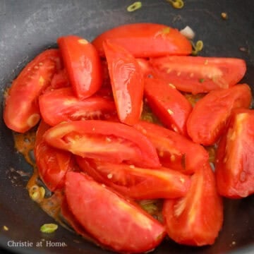 Chopped tomatoes and scallion whites cooked until softened with peeling skins.