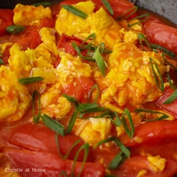 Chinese tomato egg stir-fry with soft scrambled eggs, tender tomatoes, and scallion greens.