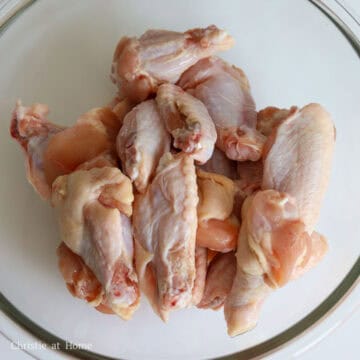 First preheat the oven to 425 F. Pat dry the chicken wings and transfer them to a large mixing bowl.