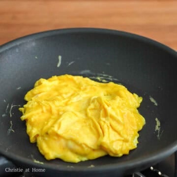 Then heat 1 teaspoon vegetable oil in a small pan on medium heat. Add beaten eggs and scramble until they take shape but look moist, about 1 minute. (Alternatively, you can fry eggs sunny-side up or over-easy until the egg whites are set, and the yolk is runny). Transfer cooked eggs over hot rice.