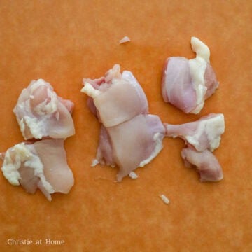 Raw chicken thighs cut into uniform bite-sized cubes.