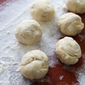 On an evenly floured surface, roll the dough into 1-inch thick log. Then cut the log into 26 x 1-inch wide pieces. Roll each piece into a ball.