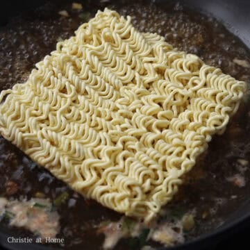 Once the water comes to a rolling simmer, add instant ramen. Cook instant ramen on each side for about 20-30 seconds.