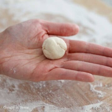 Roll each piece into a little dough ball. Cover the little balls of dough with a clean warm towel so they don't dry out.