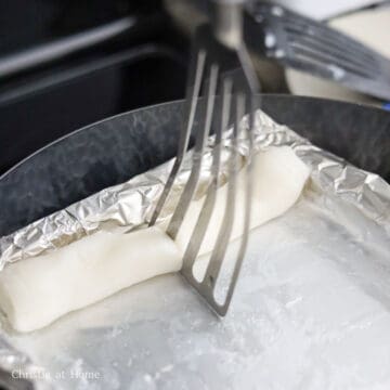 Slice in the roll in half with a thin bladed spatula or dough cutter. Transfer to your serving plate. Repeat this process until you have 3 more rolls. Garnish with sweet soy sauce, scallions, and sesame seeds and enjoy!