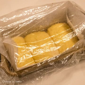 Pat the sides to make it a bit smaller to fit into your lined or greased bread pan. Repeat this for the remaining two balls of dough.