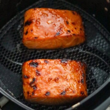 Cooked salmon filets with a bubbling, caramelized outer glaze.