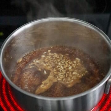 Teriyaki sauce simmering until glossy and thick.
