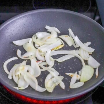 Sliced onions softening in oil.