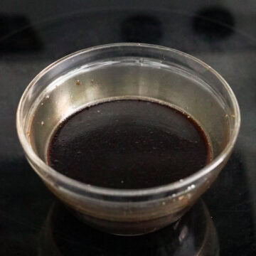 Whisking the homemade brown stir-fry noodle sauce ingredients together in a small bowl.