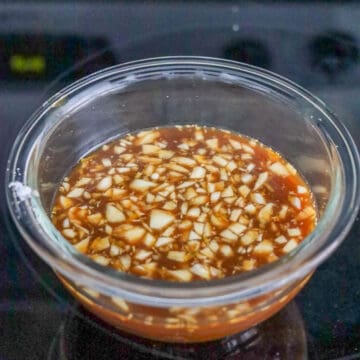 Whisking sauce ingredients in a small bowl and setting aside