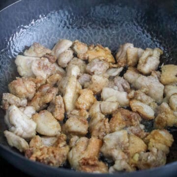 Frying chicken in a pan with hot oil until golden and crispy in small batches
Draining fried chicken on a wire rack to remove excess oil