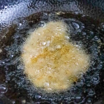 In a heavy bottom pot, heat oil over medium heat or 350 F. Once oil is hot, deep fry pork on each side until golden brown, 2 minutes per side and until the pork reaches and internal temperature of 145 F or juices run clear.