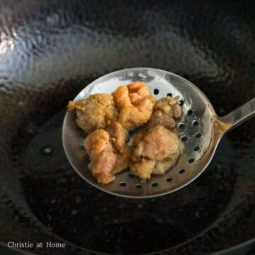 Crispy golden chicken pieces draining oil.