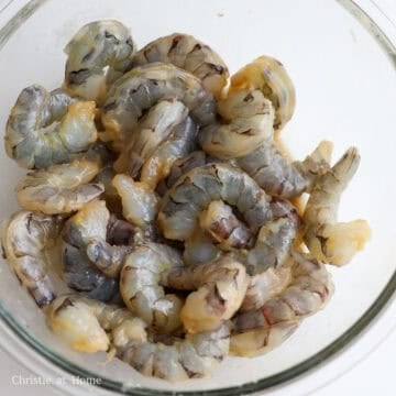 Raw shrimp coated in a translucent marinade of soy sauce and cornstarch.