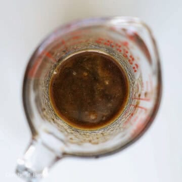 Dark, rich savory stir-fry sauce mixed in a small container.
