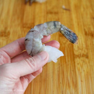 First peel deveined shrimp leaving the tails on. Then pat dry the shrimp with paper towel to remove excess moisture.