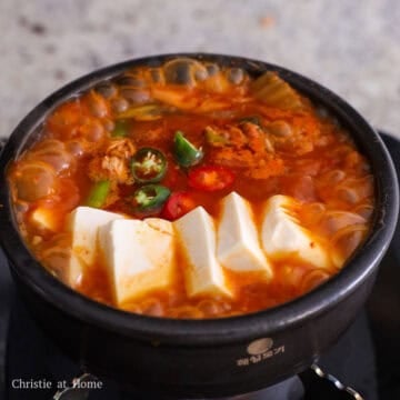 Add sliced tofu on top of the stew. Season with sesame oil. Garnish with chopped Korean chili peppers and enjoy hot with rice.