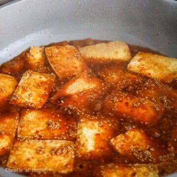 Gochujang sauce poured over golden pan-fried tofu.