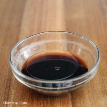 Soy sauce, Chinese black vinegar, and toasted sesame oil mixed together in a small bowl.