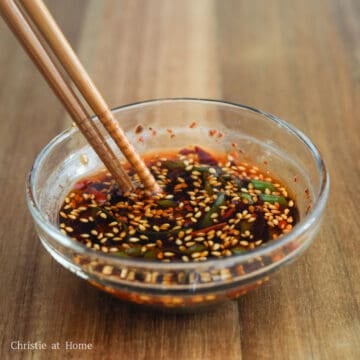 Green onions, ginger, sesame seeds, and chili oil added to the dumpling sauce.