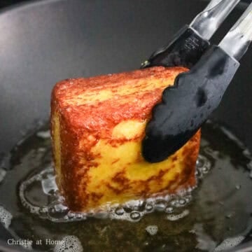 Golden brown Hong Kong-style French toast lifted from hot oil after frying.