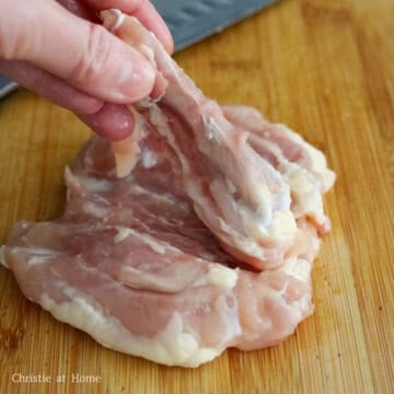 Removing the bone from a chicken thigh