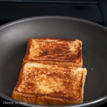 Then in a large pan on low-medium heat, melt 2 tablespoon butter and swirl it around the pan. Toast the bread on both sides until golden brown. Remove and set aside on a paper-towel lined plate or a wire rack to prevent it from becoming soggy.