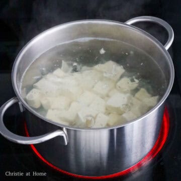 Fill a medium pot with enough water and season with salt. Bring to a boil and blanch diced tofu for 60 seconds.