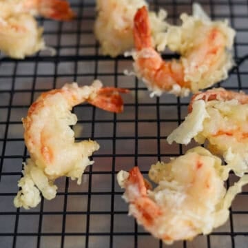 Remove fried shrimp with tongs or a slotted spoon and transfer to a wire rack or paper towel baking sheet to allow excess oil to drip off. Repeat for the remaining shrimp.Â