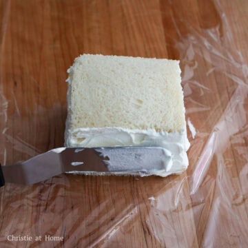 Cover the strawberries with more whipped cream, filling in any gaps. Place the second slice of bread on top and spread additional cream along the sides and corners to seal.