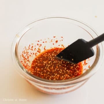 Whisked red dressing in a small bowl.