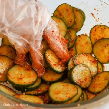 Coated cucumber salad topped with sesame seeds.