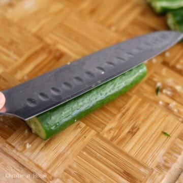 Smashed mini cucumbers cracked open lengthwise.