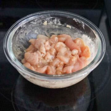 Chicken sliced against the grain and coated evenly in marinade.