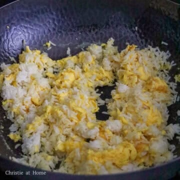 Jasmine rice and scrambled eggs toasting in a wok