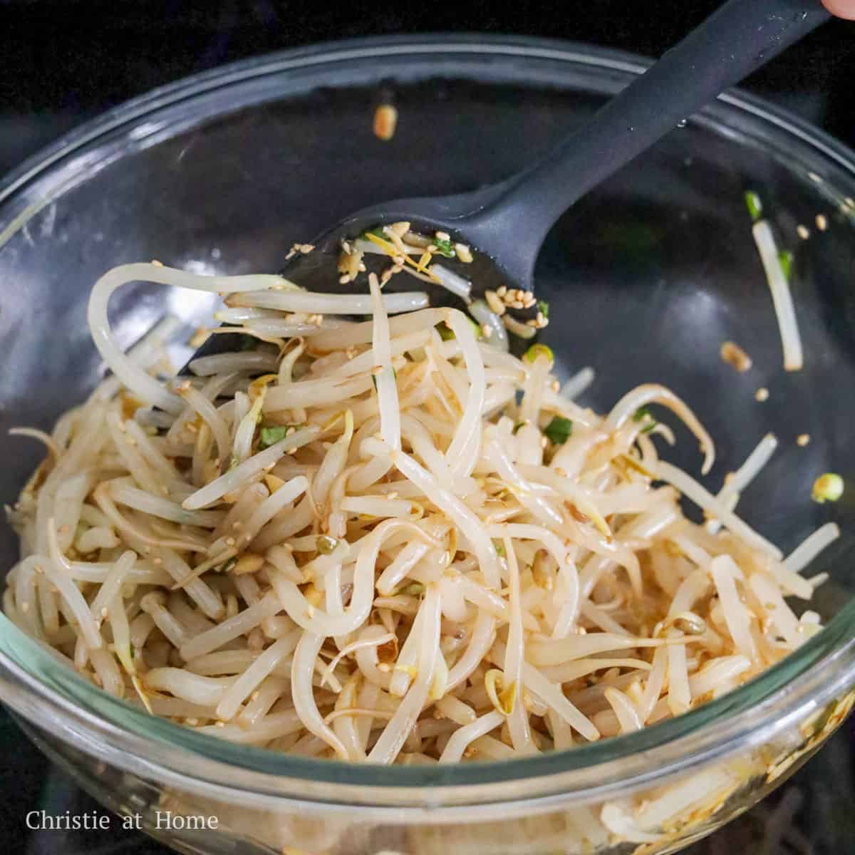 Korean bean sprout salad tossed with sesame garlic soy dressing and green onions.