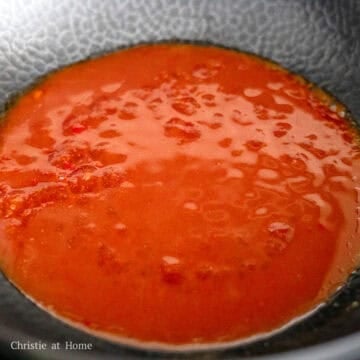Peking sauce simmering until thick, glossy, and able to coat the back of a spoon.