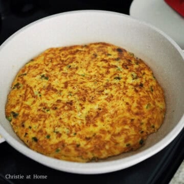 Flip pancake over with a large spatula or slide it onto a plate and then flip the pancake into the pan. Pour remaining oil around the edges of the pancake. Fry on the other side until the bottom is golden brown, about 4-6 minutes.