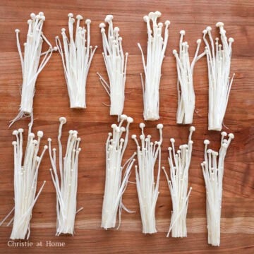 Enoki mushrooms trimmed, rinsed, and divided into bunches.