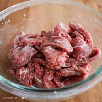 Sliced beef evenly coated in the velveting marinade.