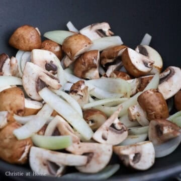 Onions and mushrooms cooked until the mushrooms are slightly softened.